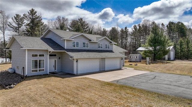 27183 250th St, Holcombe, WI 54745 - traditional-style house featuring a shingled roof, driveway, a garage, and a front lawn