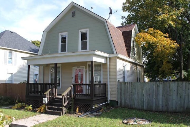 2159 Clarence Ave, Racine, WI 53405 - colonial inspired home featuring fence, a gambrel roof, a porch, and roof with shingles