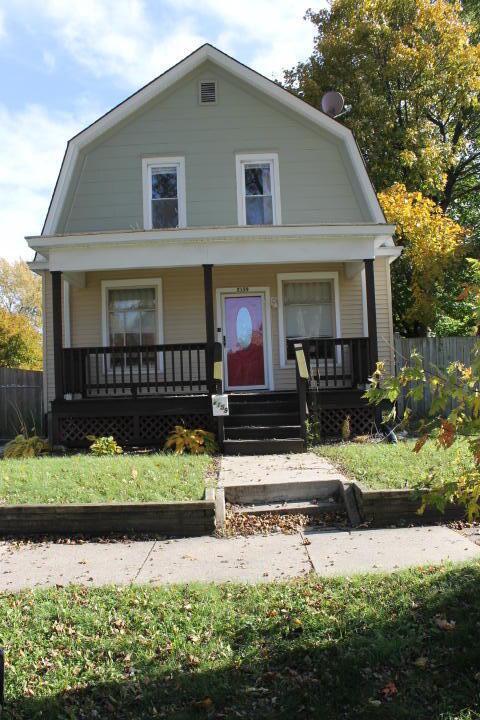 2159 Clarence Ave, Racine, WI 53405 - dutch colonial featuring covered porch, a gambrel roof, and fence