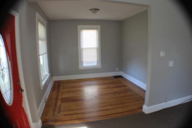 2159 Clarence Ave, Racine, WI 53405 - unfurnished dining area featuring baseboards and wood finished floors