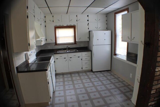 2159 Clarence Ave, Racine, WI 53405 - kitchen with a sink, dark countertops, plenty of natural light, and white appliances