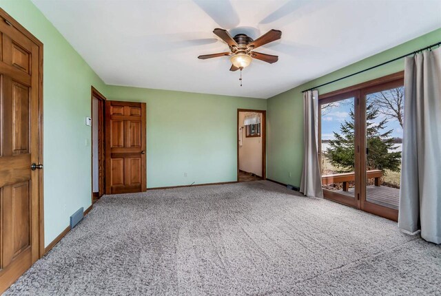 2015 Hickory Ln, Oshkosh, WI 54901 - unfurnished bedroom with access to outside, baseboards, a ceiling fan, and carpet