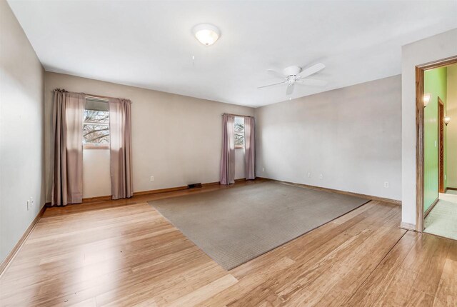 2015 Hickory Ln, Oshkosh, WI 54901 - spare room featuring visible vents, light wood finished floors, a ceiling fan, and plenty of natural light