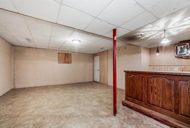 2015 Hickory Ln, Oshkosh, WI 54901 - bar featuring a bar, brick wall, a drop ceiling, and light floors