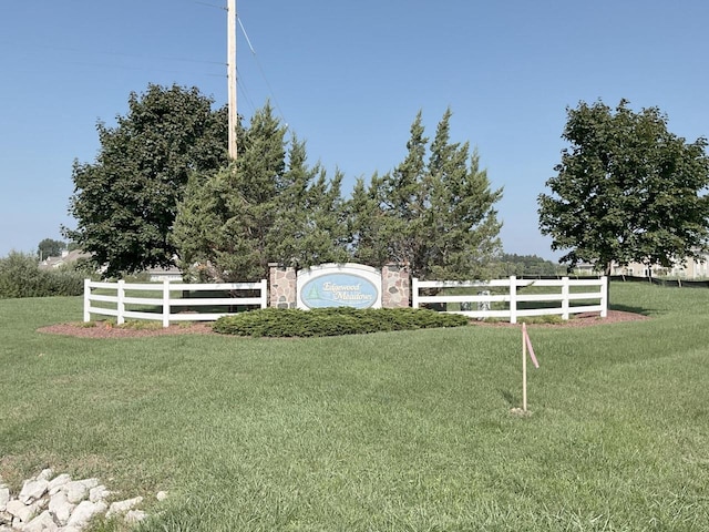 community sign with a yard and fence