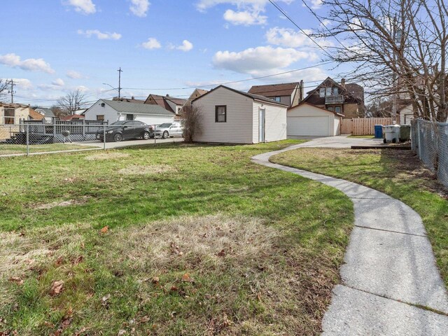 4348 N 30th St, Milwaukee, WI 53216 - view of yard featuring a fenced backyard, an outbuilding, a garage, and a residential view