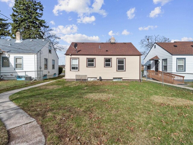 4348 N 30th St, Milwaukee, WI 53216 - rear view of house featuring fence, central AC unit, a yard, and a chimney
