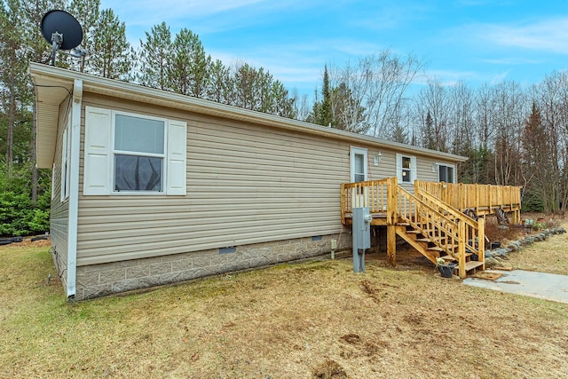 843 Sundstein Rd, Eagle River, WI 54521 - view of front of home featuring crawl space, a deck, and a front lawn