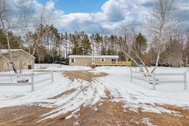 843 Sundstein Rd, Eagle River, WI 54521 - yard layered in snow with a wooden deck and an outdoor structure