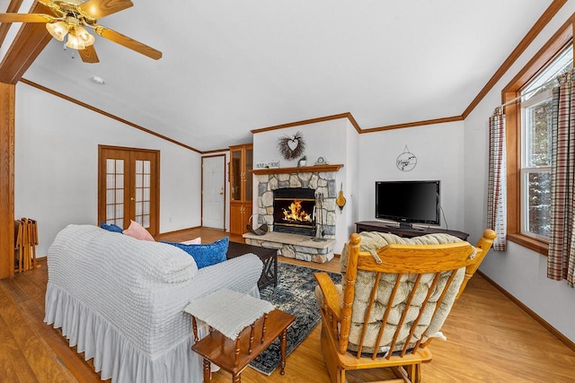 843 Sundstein Rd, Eagle River, WI 54521 - living area featuring lofted ceiling, french doors, a stone fireplace, light wood-style flooring, and crown molding