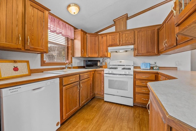 843 Sundstein Rd, Eagle River, WI 54521 - kitchen featuring white appliances, under cabinet range hood, a sink, lofted ceiling, and light wood-style flooring