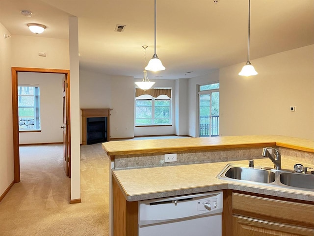 200 Femrite Dr Unit 211, Monona, WI 53716 - kitchen featuring a sink, white dishwasher, light colored carpet, a fireplace, and hanging light fixtures
