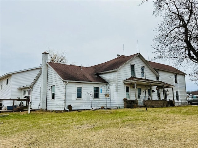 W1797 County Road A, Mindoro, WI 54644 - back of house featuring a lawn, roof with shingles, covered porch, and a chimney