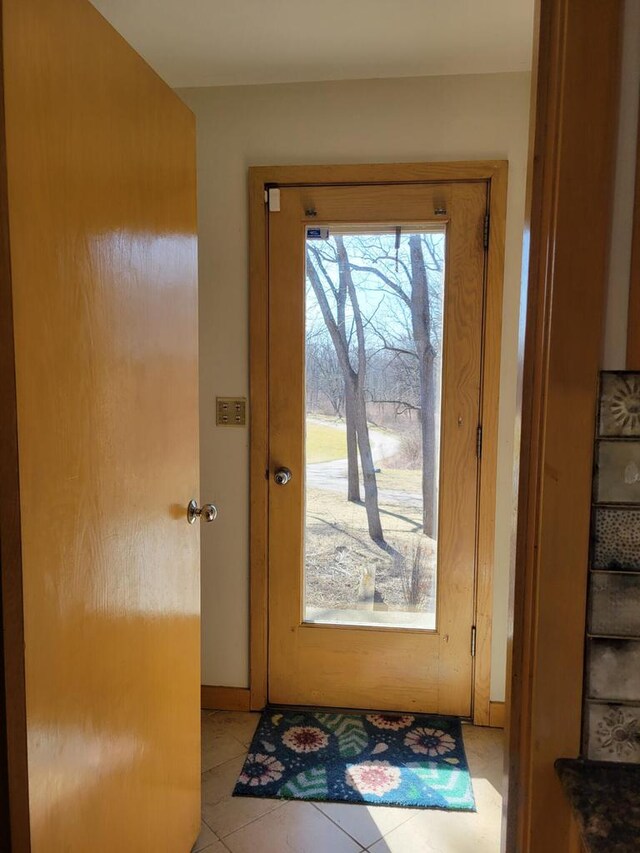 8100 160th Ave, Bristol, WI 53104 - doorway with baseboards and light tile patterned floors