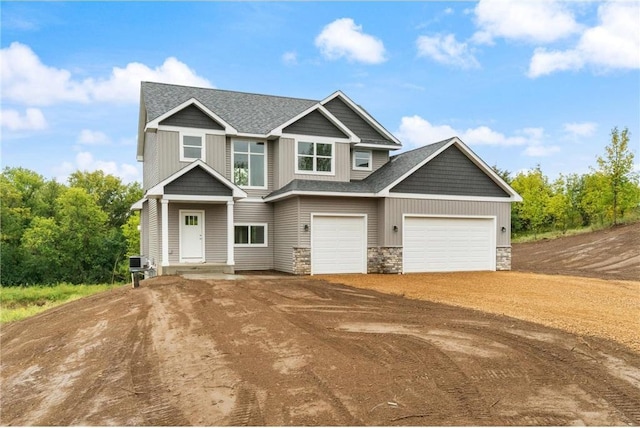 721 Jacko Ct, Hudson, WI 54016 - craftsman-style home featuring cooling unit, stone siding, dirt driveway, and a garage