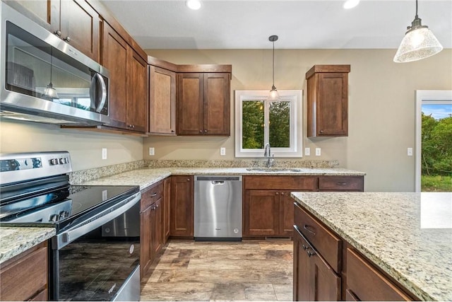 kitchen featuring recessed lighting, pendant lighting, a sink, and appliances with stainless steel finishes