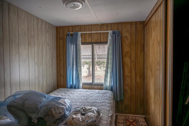 N7363 Wahneeta Ave, New Lisbon, WI 53950 - bedroom with a textured ceiling and wood walls