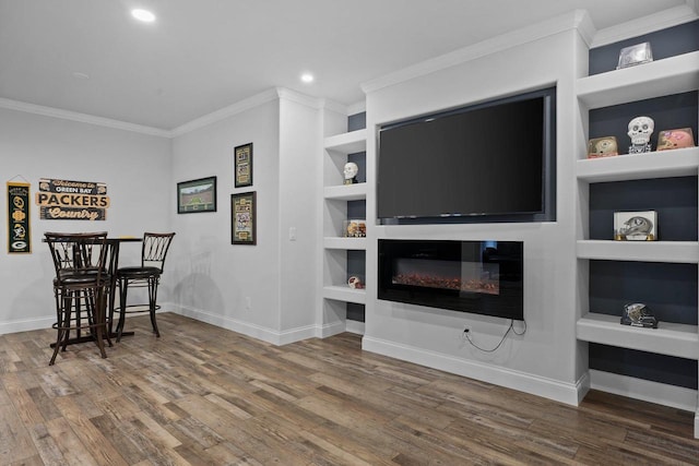 6612 Florance Ruth Ln, Sun Prairie, WI 53590 - living area featuring crown molding, built in shelves, wood finished floors, baseboards, and recessed lighting