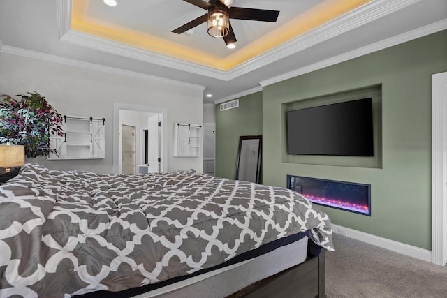 6612 Florance Ruth Ln, Sun Prairie, WI 53590 - carpeted bedroom featuring a raised ceiling, recessed lighting, ornamental molding, a glass covered fireplace, and baseboards
