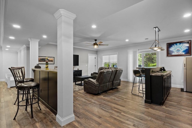 6612 Florance Ruth Ln, Sun Prairie, WI 53590 - living area with decorative columns, ornamental molding, hardwood / wood-style flooring, a ceiling fan, and recessed lighting