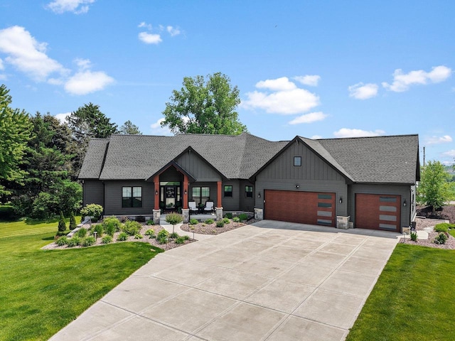 6612 Florance Ruth Ln, Sun Prairie, WI 53590 - view of front of house featuring a garage, a front lawn, concrete driveway, board and batten siding, and a porch