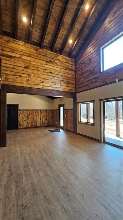 11960 US Highway 63, Hayward, WI 54843 - unfurnished living room featuring wooden ceiling, wood finished floors, high vaulted ceiling, and beam ceiling