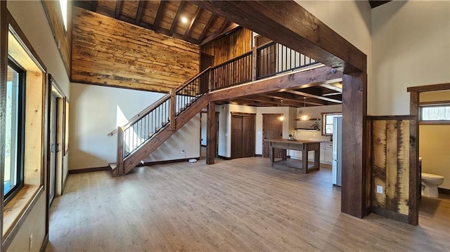11960 US Highway 63, Hayward, WI 54843 - unfurnished living room with stairway, wood ceiling, high vaulted ceiling, and wood finished floors
