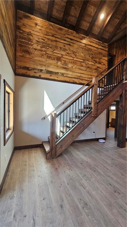 11960 US Highway 63, Hayward, WI 54843 - unfurnished living room featuring wood ceiling, wood finished floors, and beamed ceiling