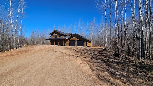 11960 US Highway 63, Hayward, WI 54843 - chalet / cabin featuring dirt driveway and a garage