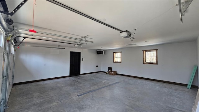 11960 US Highway 63, Hayward, WI 54843 - garage featuring baseboards, a wall mounted AC, and a garage door opener
