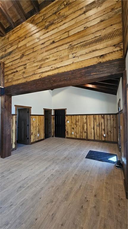 11960 US Highway 63, Hayward, WI 54843 - bonus room featuring a wainscoted wall, wood walls, wood finished floors, and lofted ceiling with beams