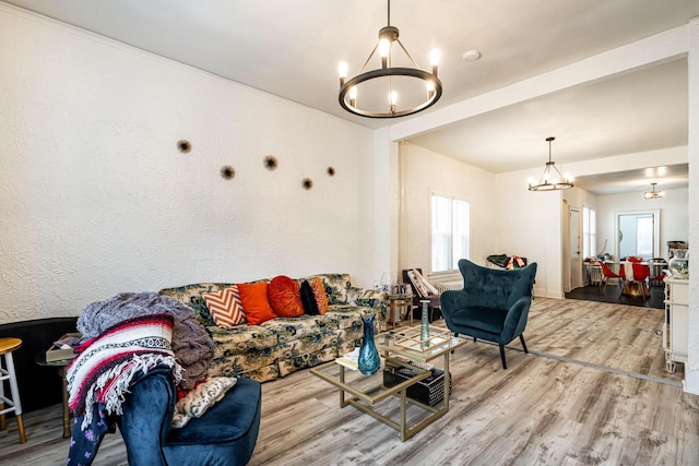 living area with a notable chandelier and wood finished floors