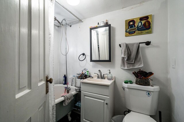 bathroom featuring toilet, shower / bath combination with curtain, and vanity