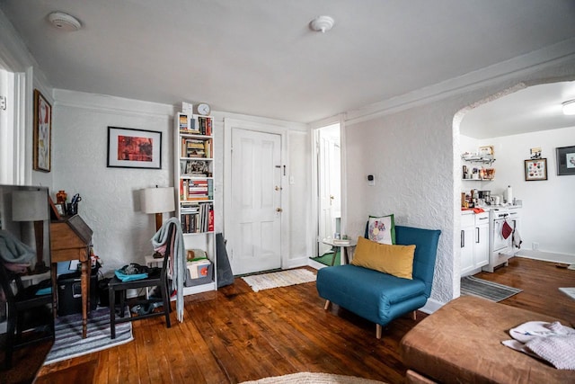 interior space featuring hardwood / wood-style floors, baseboards, and a textured wall