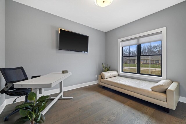 home office with baseboards and wood finished floors