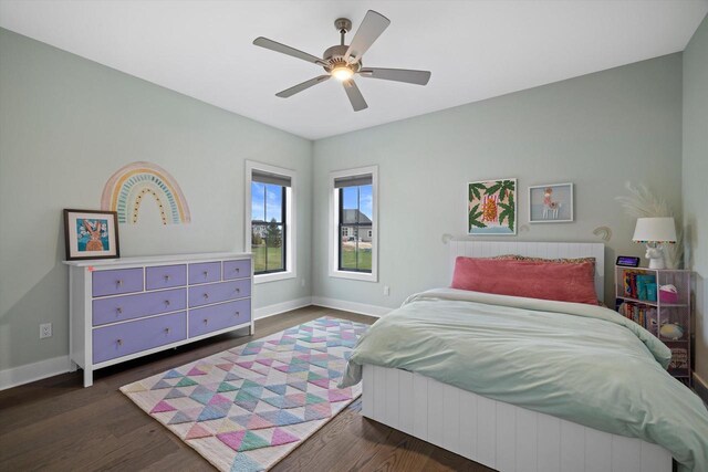 bedroom featuring baseboards, a ceiling fan, and dark wood finished floors