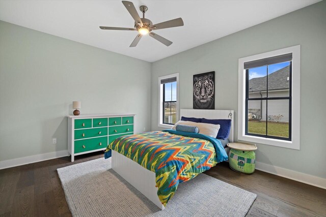 bedroom with baseboards, a ceiling fan, and wood finished floors