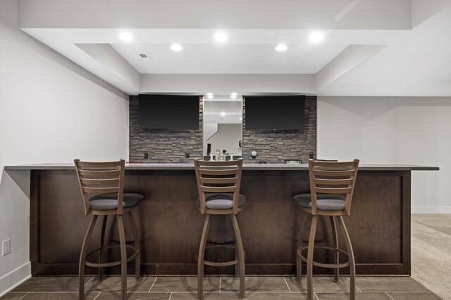 bar featuring recessed lighting, visible vents, baseboards, and wet bar