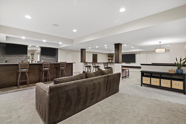 living room with light colored carpet, wet bar, and recessed lighting