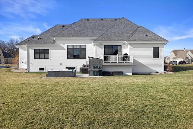 back of property with outdoor lounge area, a shingled roof, and a lawn