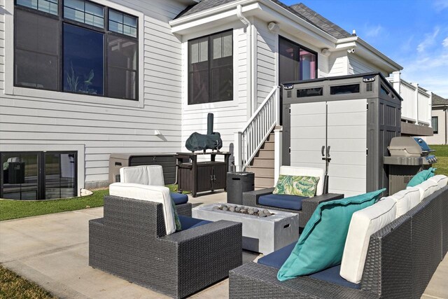 view of patio / terrace featuring an outdoor living space with a fire pit and grilling area
