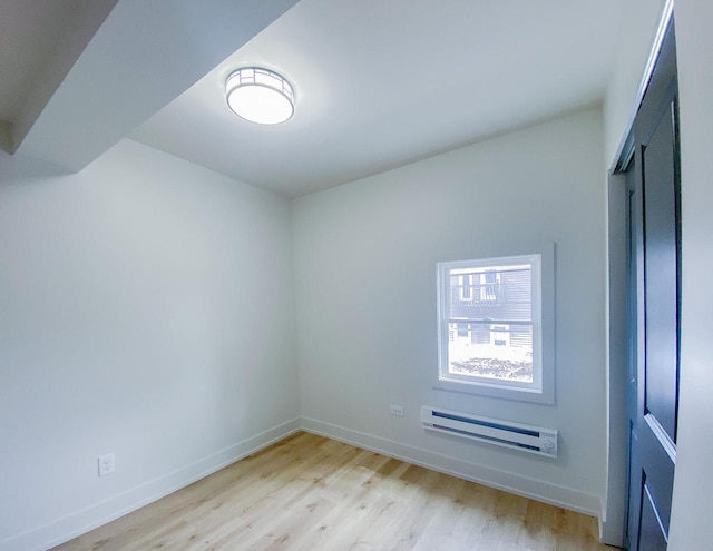 spare room with light wood-style flooring and baseboards