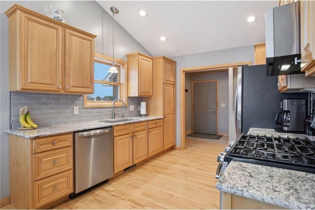kitchen featuring range hood, a sink, stainless steel appliances, light wood-style flooring, and lofted ceiling