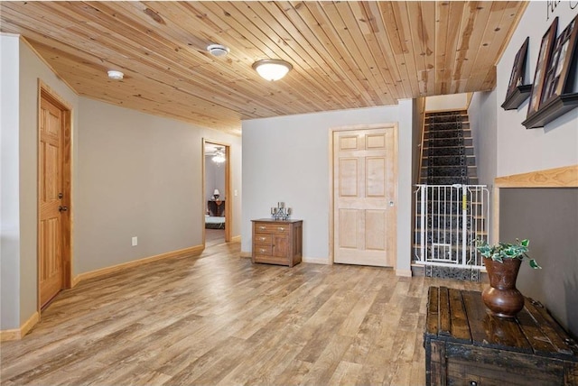 interior space featuring baseboards, wood finished floors, and wood ceiling