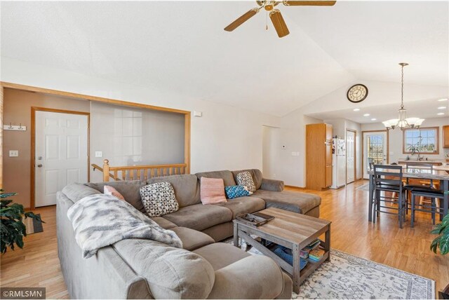 219 Bluff Dr, Somerset, WI 54025 - living area with light wood-style flooring, ceiling fan with notable chandelier, and vaulted ceiling