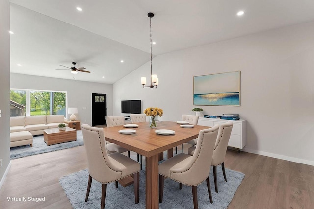 216 S Dewey Ave, Reedsburg, WI 53959 - dining space with vaulted ceiling, light wood-style floors, a ceiling fan, a chandelier, and baseboards