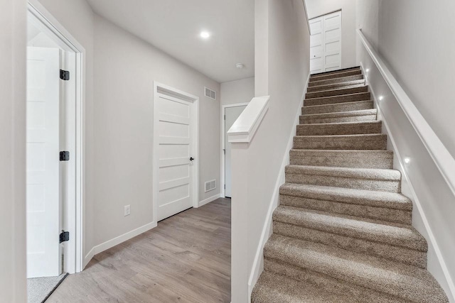 216 S Dewey Ave, Reedsburg, WI 53959 - staircase with wood finished floors, baseboards, and recessed lighting