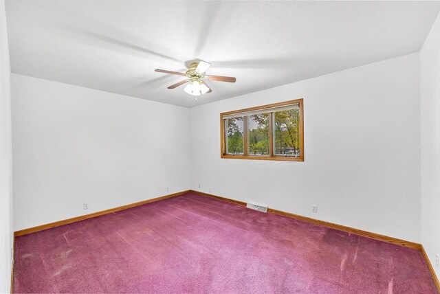 W8547 Cloverleaf Lake Rd, Clintonville, WI 54929 - unfurnished room with ceiling fan, dark carpet, and baseboards