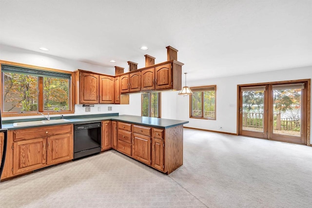 W8547 Cloverleaf Lake Rd, Clintonville, WI 54929 - kitchen with black dishwasher, a sink, brown cabinetry, a peninsula, and light colored carpet