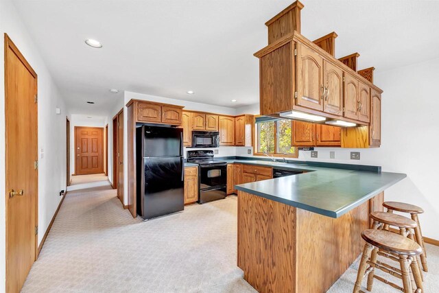 W8547 Cloverleaf Lake Rd, Clintonville, WI 54929 - kitchen featuring black appliances, a peninsula, light colored carpet, a kitchen bar, and recessed lighting